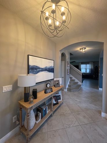 Cozy, well-lit hallway with modern decor and stairs.