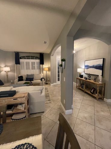 Cozy living room and hallway with neutral tones and warm lighting.