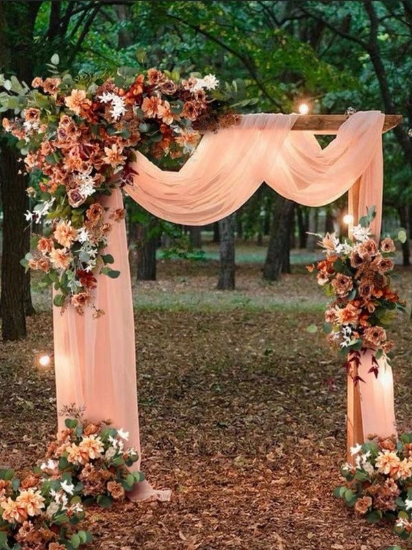 Gorgeous arch for outdoor wooded ceremony. The bright peach against the natural background=stunning