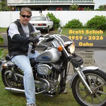 Man on a motorcycle with tribute text.