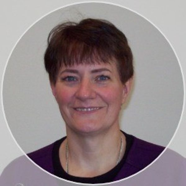 Smiling woman with short brown hair.