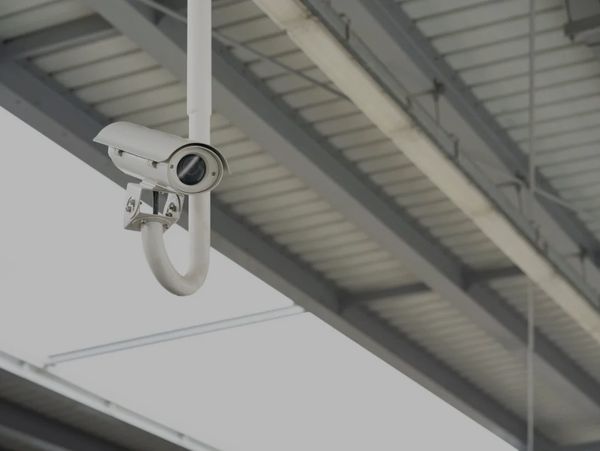 Outdoor surveillance camera hanging down from a roof