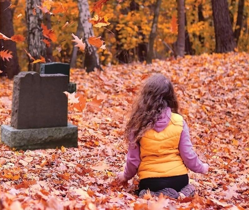 Cropping of Perfect Imperfections Cover. Girl in woods, kneeling before headstones