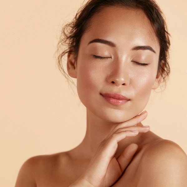 Closeup shot of a woman holding her chin with eyes closed