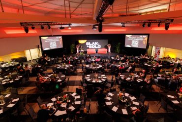 Conference titled 'Blak & Bold' with attendees seated at round tables.