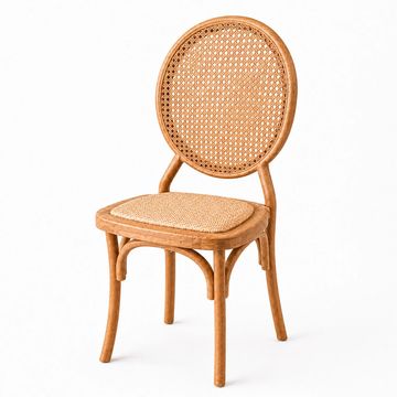 A rattan chair with a circular woven backrest and cushioned seat.