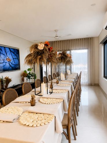 Elegant dining setup with dried floral centerpieces and woven placemats.