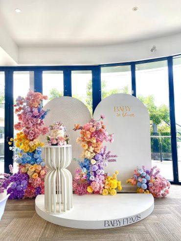 Elegant floral baby shower setup with pastel colors and modern decor.