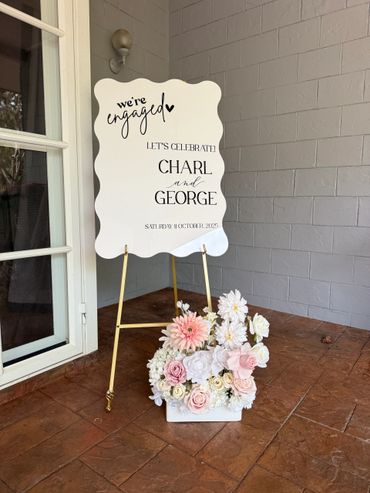 Elegant engagement sign for Charl and George with floral decoration.