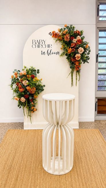 Elegant floral display with orange and green hues on a white backdrop.