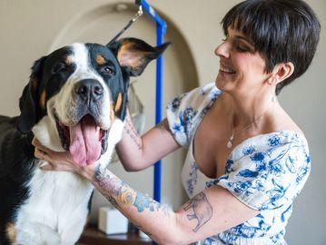 Woman with a large dog, both happy.