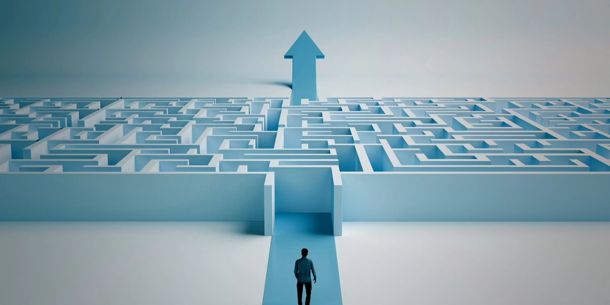 A person faces a maze with a clear arrow pointing upward as the way out.
