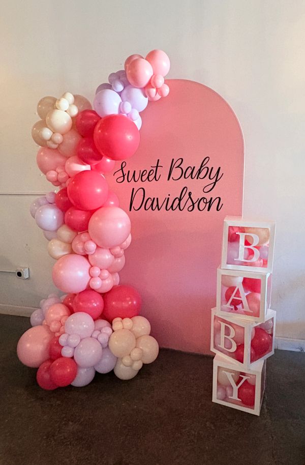 Pink balloon arrangement with 'Sweet Baby Davidson' sign and BABY blocks.