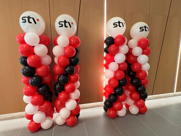 Four balloon columns with stv logos on top.