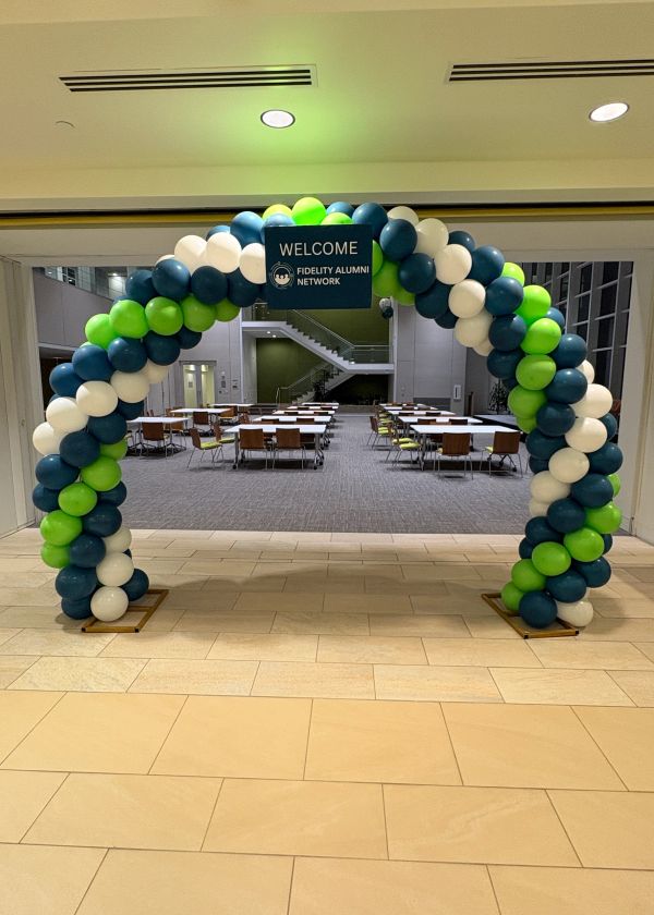 Colorful balloon arch welcoming Fidelity Alumni Network.