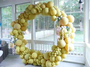 Yellow balloon wreath decoration indoors.