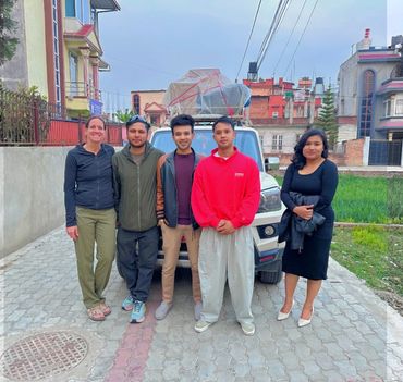 Group photo of foundation members and volunteers in front of our transportation to our Sindhuli and 
