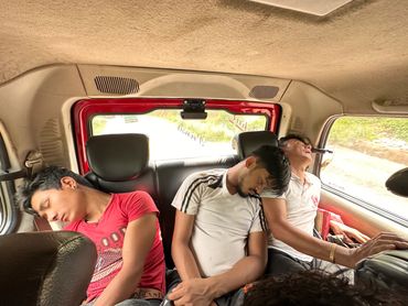 People sleeping in a vehicle.