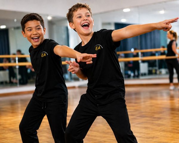 Two boys joyfully dancing and pointing in a dance studio.