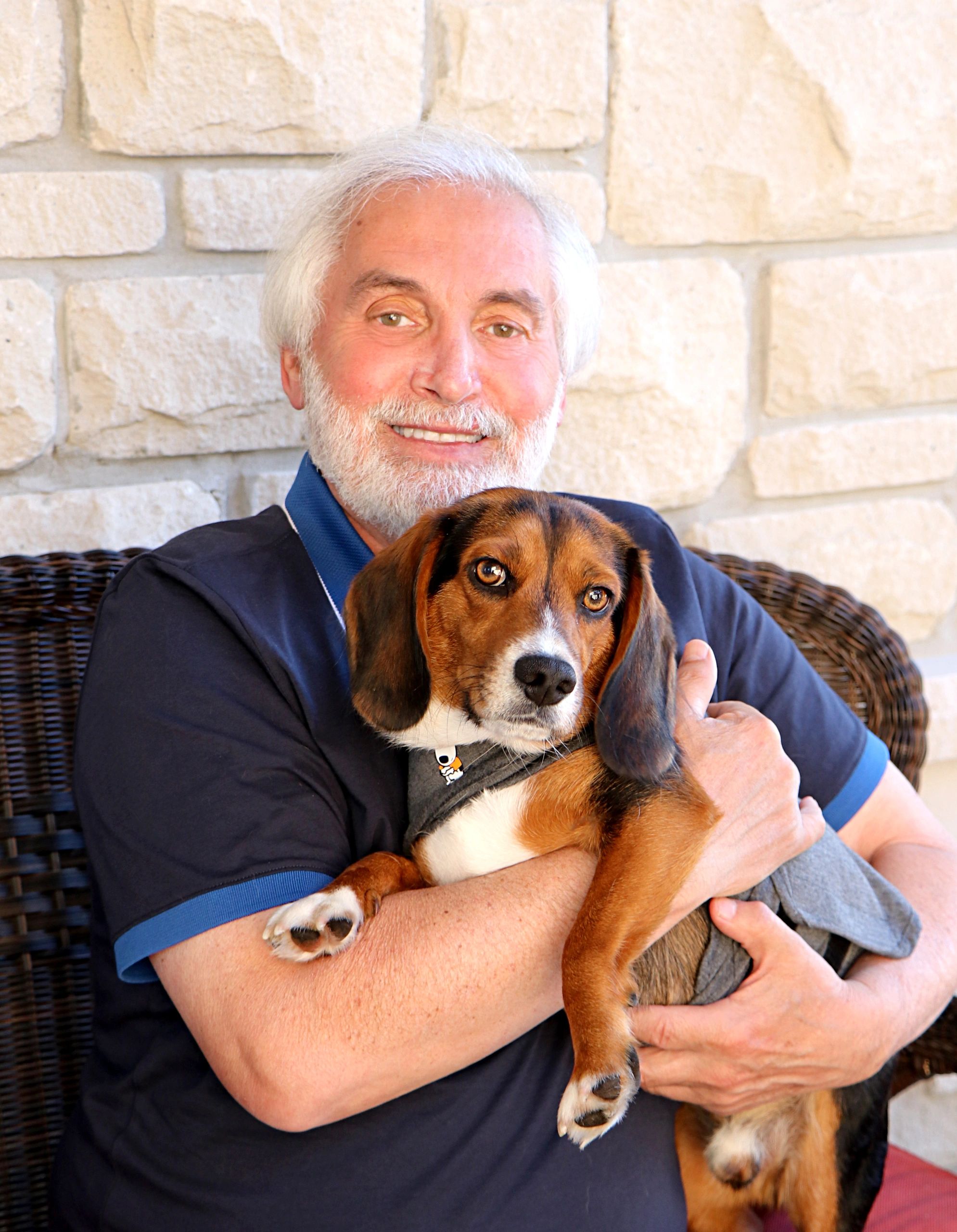 Man smiling holding his dog