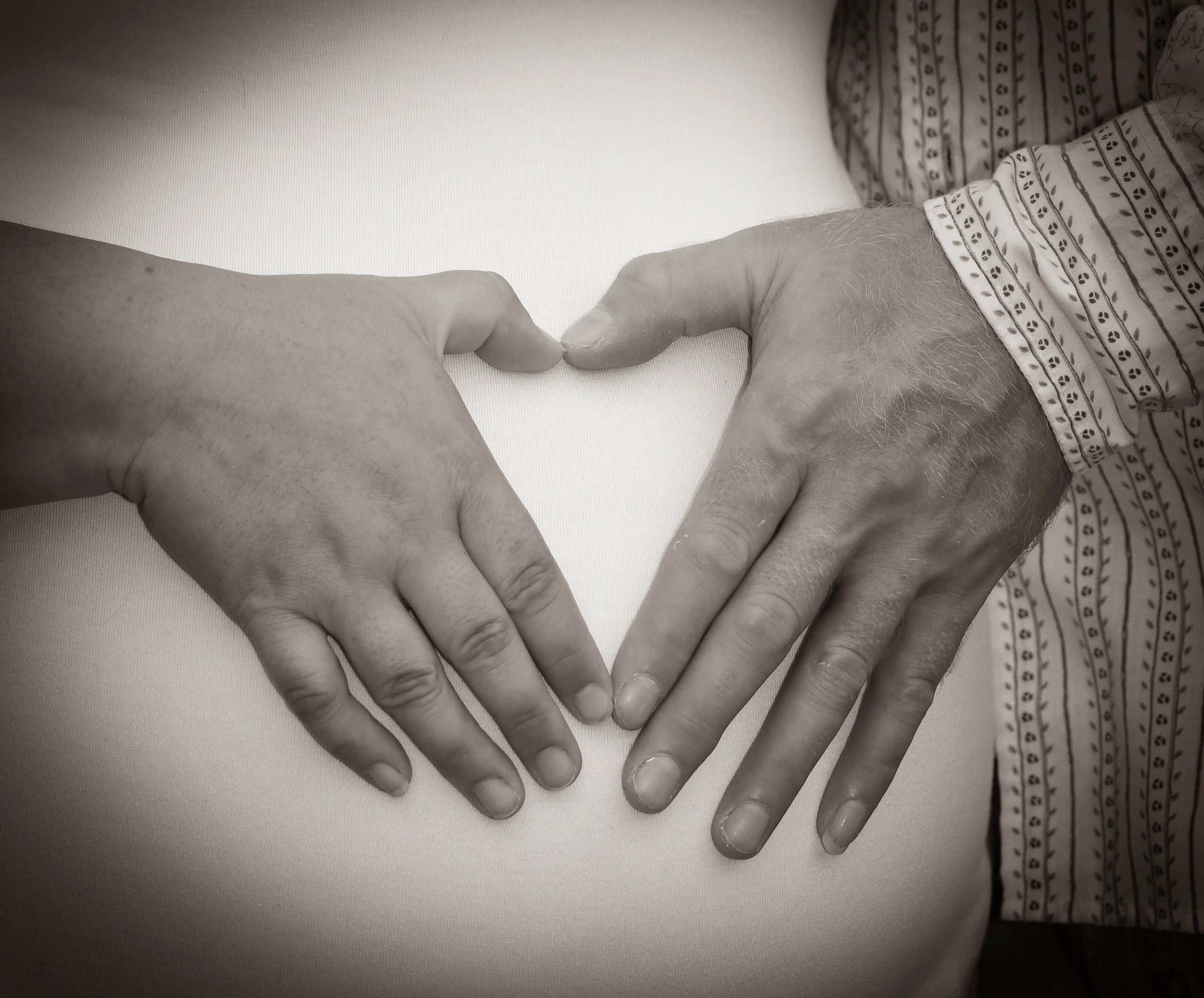 heart-shaped hands on belly