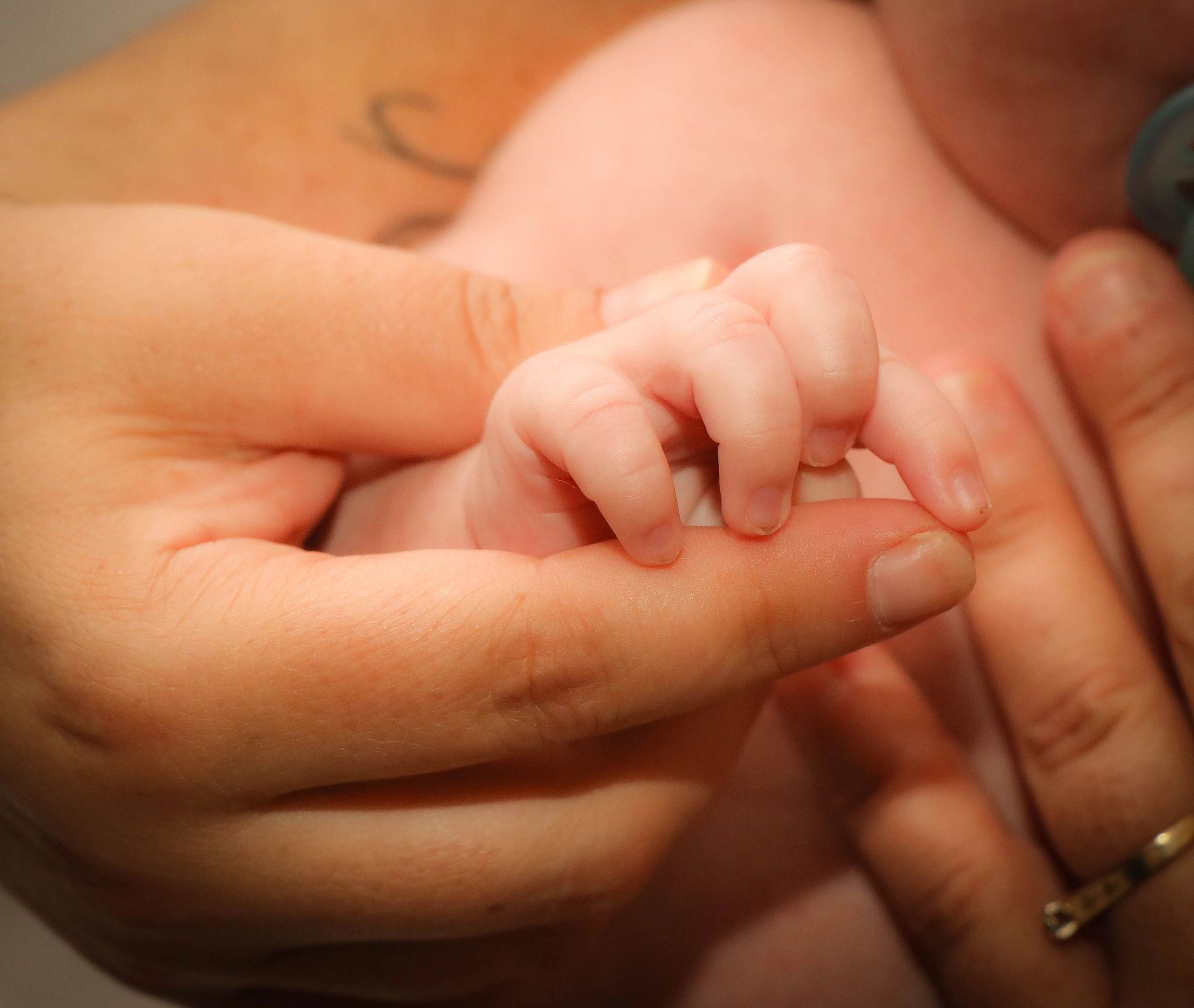 mom holding baby's hand