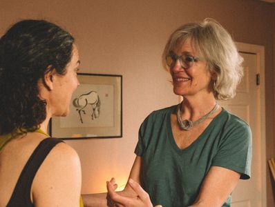 Two women sharing a warm, joyful moment indoors.