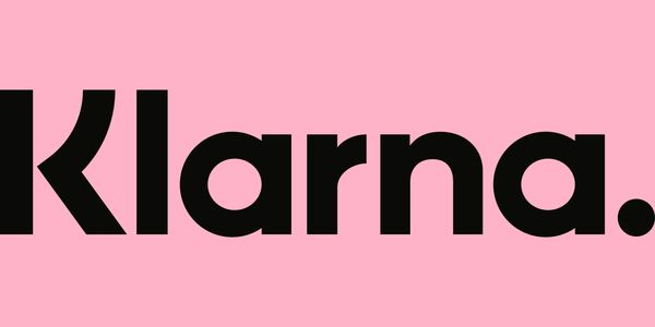 Klarna logo in bold black font on a pink background.