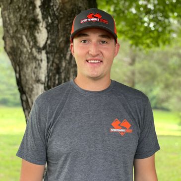 Man wearing a Sportsman's Warehouse hat and shirt outdoors.
