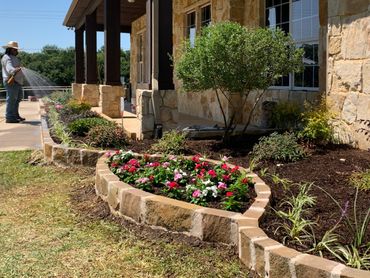 Sandstone flowerbed border , flowers , plants , drainage , soil , mulch installation 