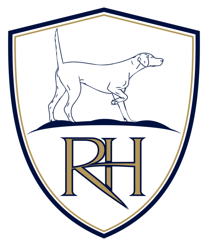 Stack of books next to pencils in a holder and a camera.