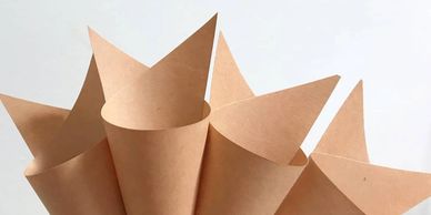 100% recyclable handmade paper cones, in Ivory or brown. Price $1.00 each.