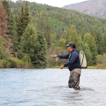 Fly fishing for rainbow trout on the upper section of the Kenai River near Cooper Landing, Alaska