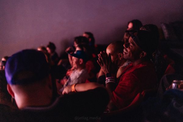 Audience enjoying a live event in a dark room.
