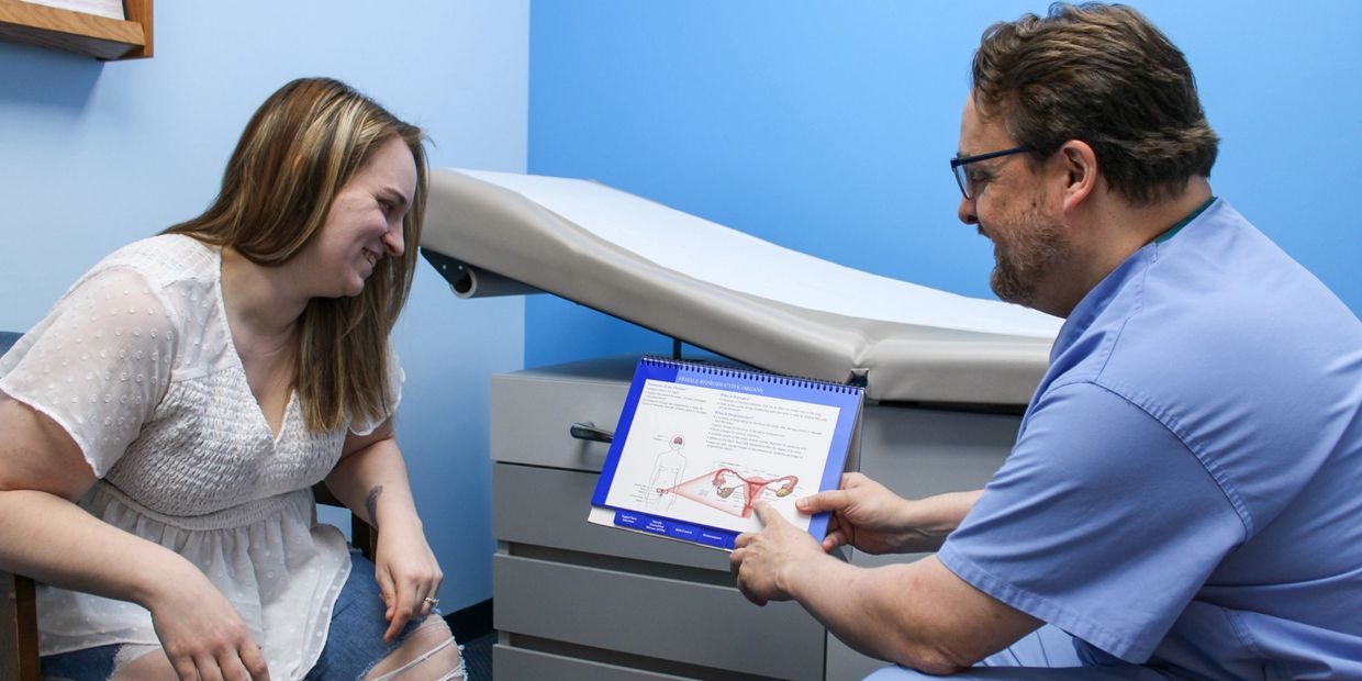 Dr.Ensley explaining an informational diagram to a patient