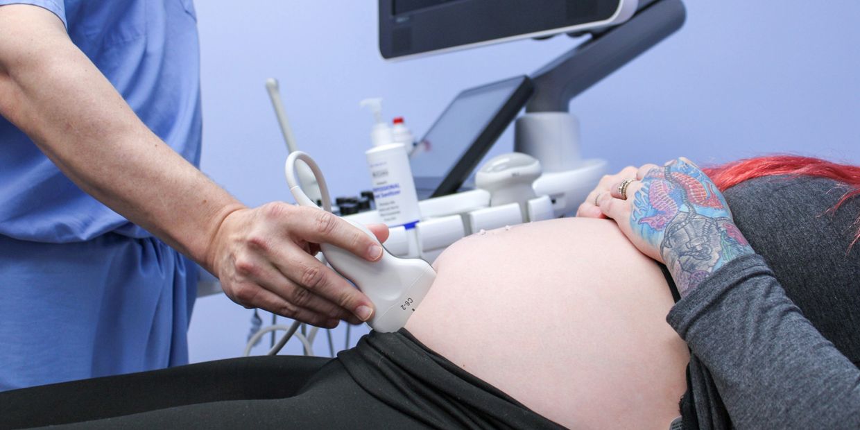 Dr. Ensley giving an ultrasound scan to a patient