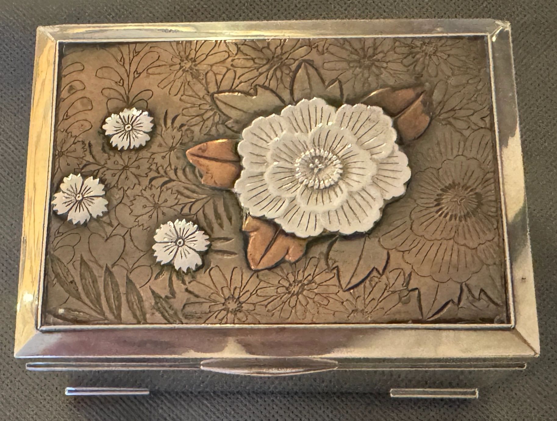 Silver box set with shakudo and mixed metals floral panel. Mitsukoshi, Meiji era.