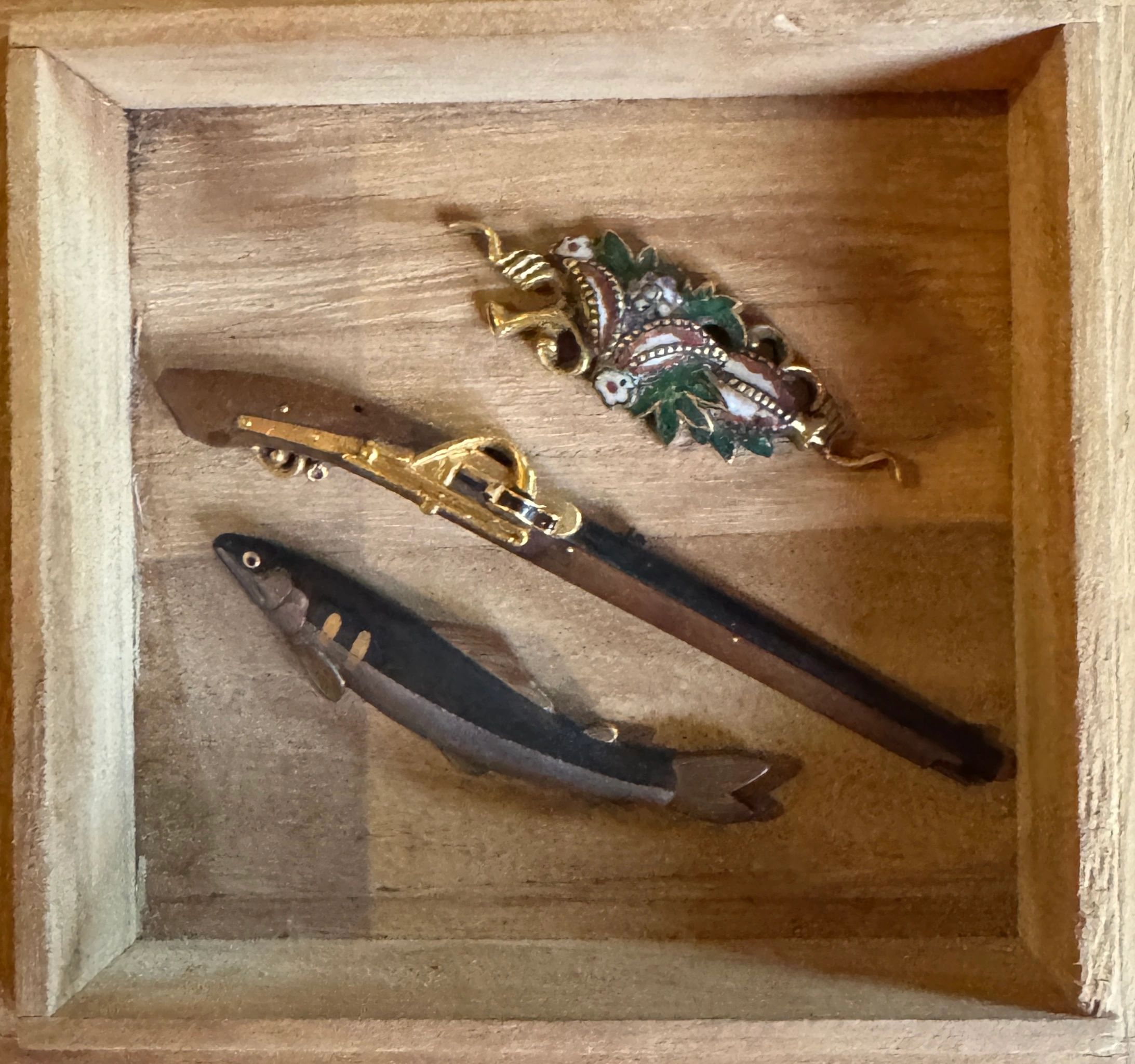 Menuki - sword handle fittings using iron, brass, copper, gold, silver and Shakudo. A Haruoki school Namazu fish, a Tanegashima (matchlock rifle) and a Hirata school enameled example. Edo era