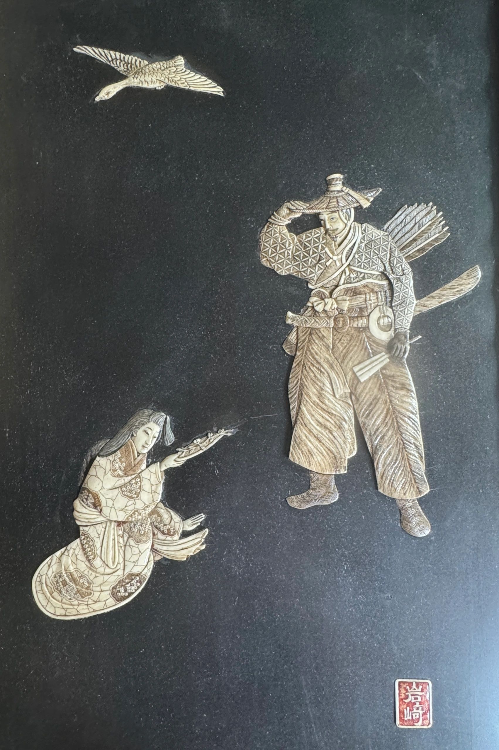Shibayama plaque depicting the wife of a Kamakura era Bushi (warrior) presenting him a Sakura sprig (cherry blossom). Signed Iwasaki in a red lacquer reserve. Meiji era.