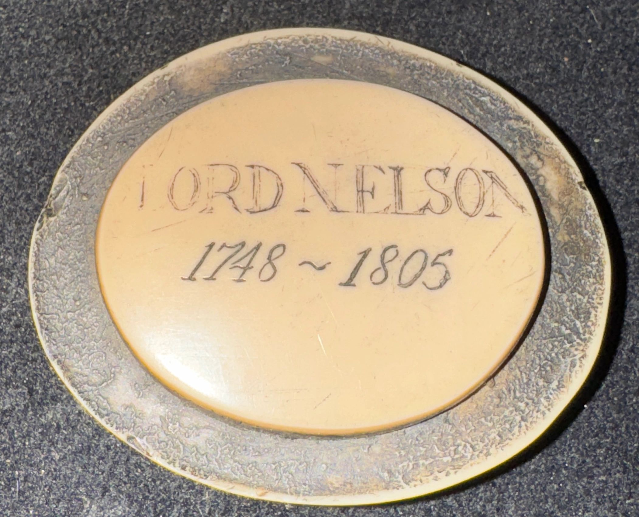 HMS Victory Trafalgar artifact: Scrimshaw medallion inscribed: LORD NELSON 1748 - 1805