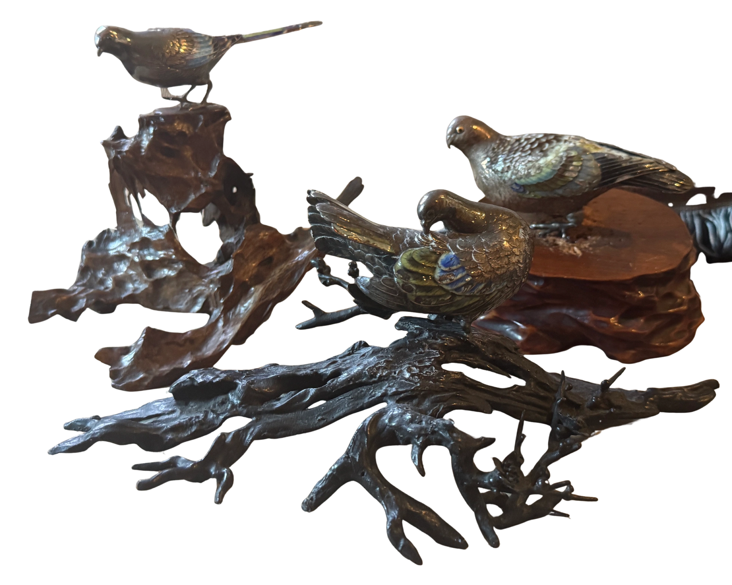 Group of enameled silver birds - a preening dove perched on stylized bronze branch, a wagtail signed by Kozan on a root wood stand and another dove. Meiji era