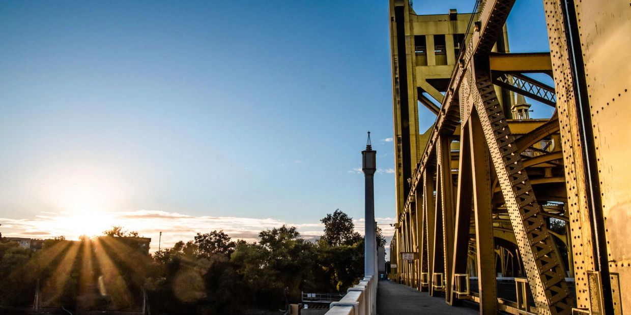 A vibrant view of the Tower Bridge in Sacramento, California, featuring its iconic golden structure 