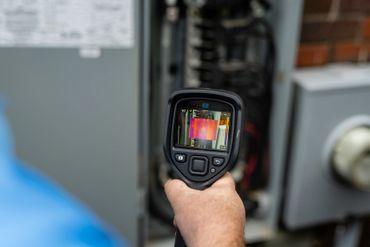 Checking the electrical service panel on the exterior of the house.