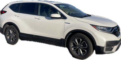 White Honda CR-V parked outdoors with sporty black rims.