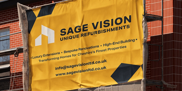 Yellow banner advertising Sage Vision refurbishment services on a building site.