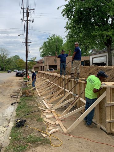 215 ft long concrete retaining wall in the Evergreen District  (corner of Stonewall and Overton Park