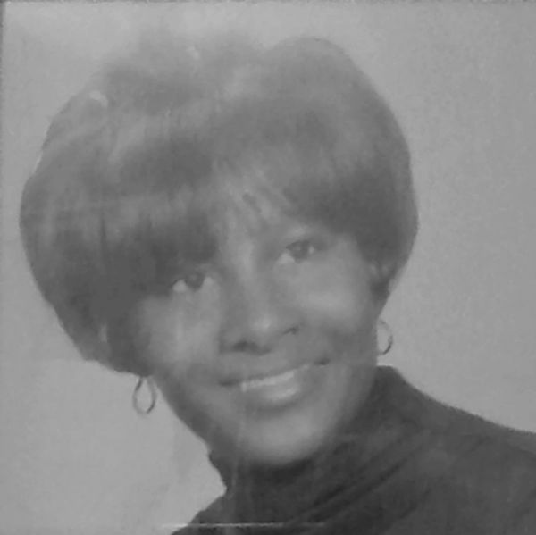 Black and white portrait of a smiling woman.