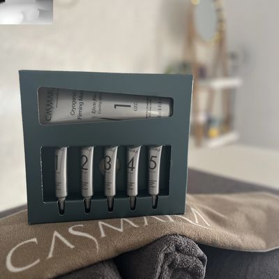 green treatment box on table, with 5 small tubes and 1 big tube 