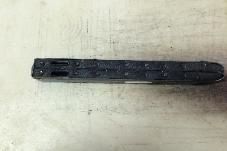 Black leather strap with multiple holes on a beige surface.