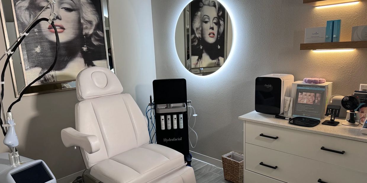 Modern spa room with white treatment chair and Marilyn Monroe artwork.